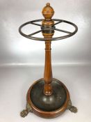 Circular umbrella /stick stand with turned central column, on claw feet, with metal drip tray,