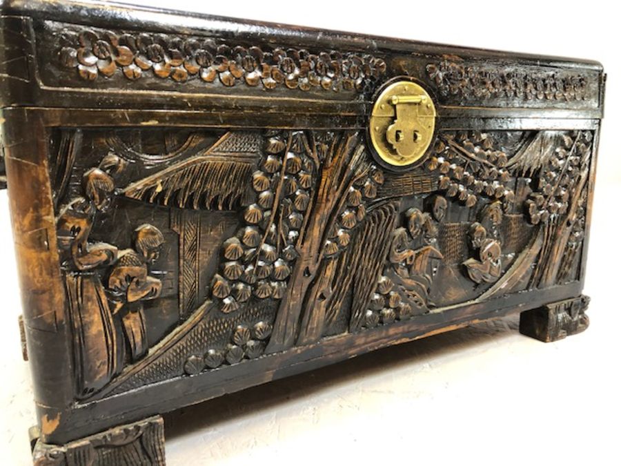 Small heavily carved Chinese camphor wood chest with brass fittings on square carved feet, approx - Image 5 of 9