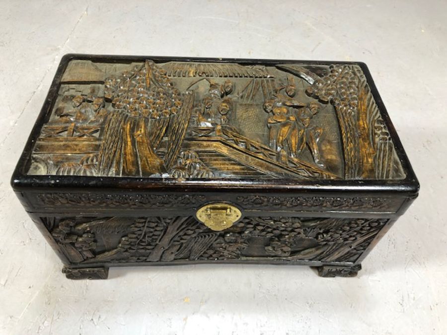 Small heavily carved Chinese camphor wood chest with brass fittings on square carved feet, approx - Image 2 of 9