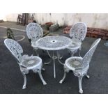 Circular white metal garden table and four chairs, table approx 68cm in diameter