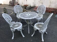 Circular white metal garden table and four chairs, table approx 68cm in diameter
