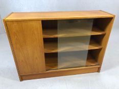 Mid Century sideboard comprising cupboard and shelving unit with two glass sliding doors, approx