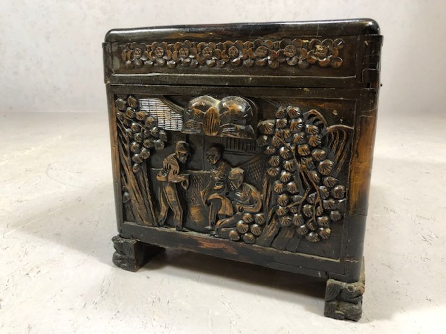 Small heavily carved Chinese camphor wood chest with brass fittings on square carved feet, approx - Image 8 of 9