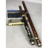 Small collection of musical instruments to include two wooden wind instruments, possibly piccolo,