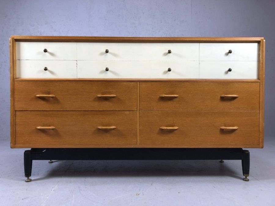 G-Plan Mid Century sideboard of ten drawers on black lacquered feet with brass detailing, six