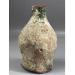 Small terracotta vase / bottle with remnants of green glaze to neck areas and white to body,