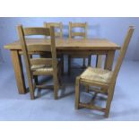 Pine kitchen table with four rush-seated chairs, table approx 153cm x 69cm x 79cm tall