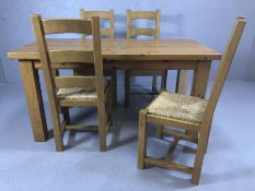 Pine kitchen table with four rush-seated chairs, table approx 153cm x 69cm x 79cm tall