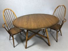 Ercol drop leaf dining table, oval top raised on four splayed square supports with 'X' stretcher,