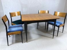 G-plan Mid Century teak and black lacquered extending dining table with four matching chairs,
