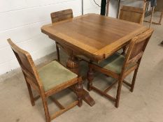 Light oak extending table with four matching chairs of Mid Century style