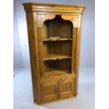 Pine corner unit with two shelves and cupboard under, approx 108cm wide x 182cm tall