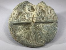 Circular stone carving, the top half depicting four figures holding objects in their hands, the