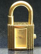 Hermes ladies Kelly padlock watch, gold plated with Champagne dial, dot numerals and baton hands,