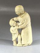 Carved bone folk art-type figure of a woman and child, approx 10cm in height