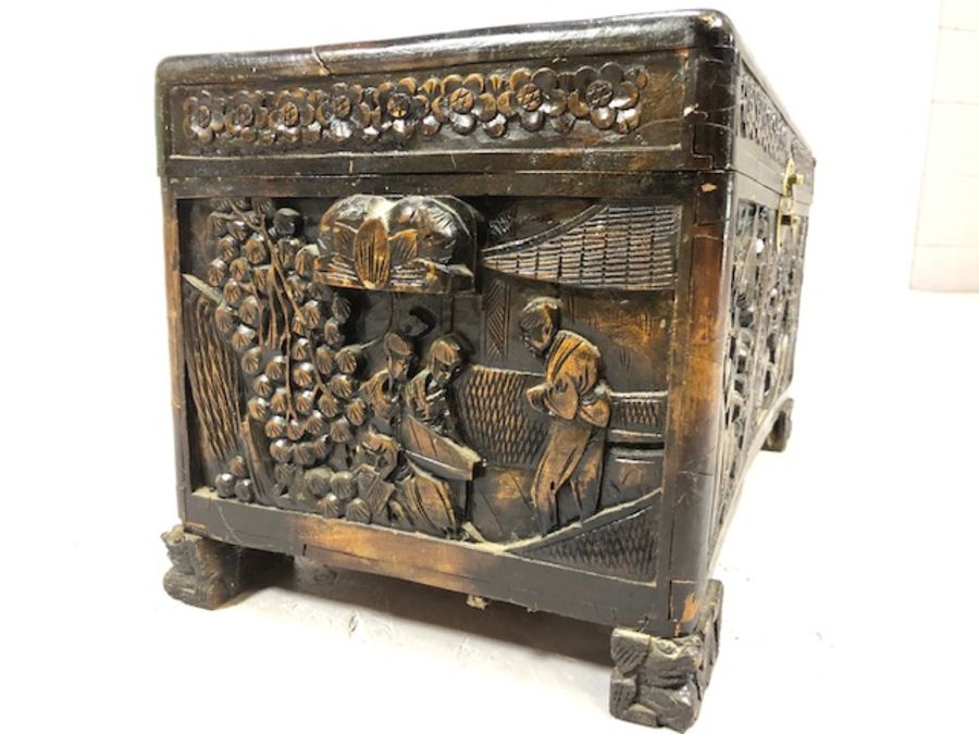 Small heavily carved Chinese camphor wood chest with brass fittings on square carved feet, approx - Image 6 of 9