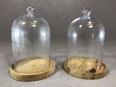 Pair of vintage glass cheese domes on wooden bases, approx 33cm in height