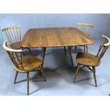 Blond Ercol drop leaf dining room table and four blond stick back chairs (pair of straight stick