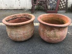 Pair of circular rib design terracotta planters, approx 35cm in diameter