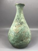 Metal, possibly copper vase of with tapering and slightly flared neck with remnants of applied