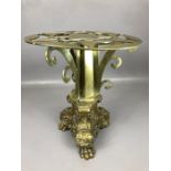 Heavy brass ornate stand with pierced star design and three scroll feet on lion paws, approx 32cm