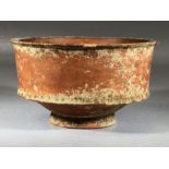 Small vessel, possibly Roman terra sigilatta, on single low food, approx 10cm in diameter x 6cm in