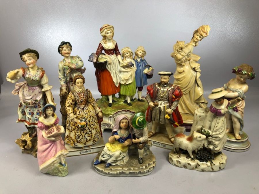 Collection of ceramic figurines to include a lady holding a dog signed B. Merli, a Staffordshire