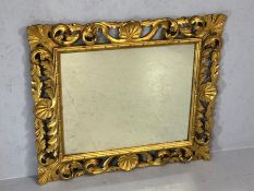 Ornate gilt wood framed oblong mirror, approx 70cm x 81cm