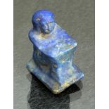 Lapis Lazuli miniature block statue or amulet depicting a man squatting with his knees drawn up to