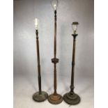 Three wooden turned and carved standard lamps, the tallest approx 172cm