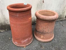 Two terracotta chimneys, the largest approx 40cm tall
