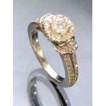 A modern 14 carat white gold diamond "Love" ring by Vera Wang, set with over 60 Diamonds the central