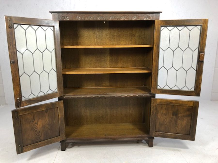 Oak linen fold book case with leaded and glazed doors, cupboard under, approx 99cm x 33cm x 135cm - Image 3 of 4