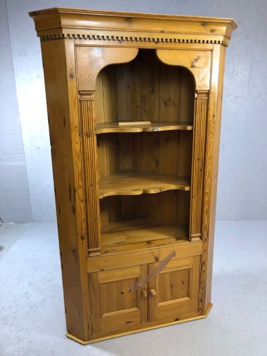 Pine corner unit with two shelves and cupboard under, approx 108cm wide x 182cm tall