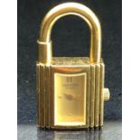 Hermes ladies Kelly padlock watch, gold plated with Champagne dial, dot numerals and baton hands,