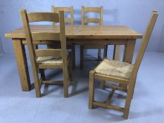 Pine kitchen table with four rush-seated chairs, table approx 153cm x 69cm x 79cm tall, labelled '