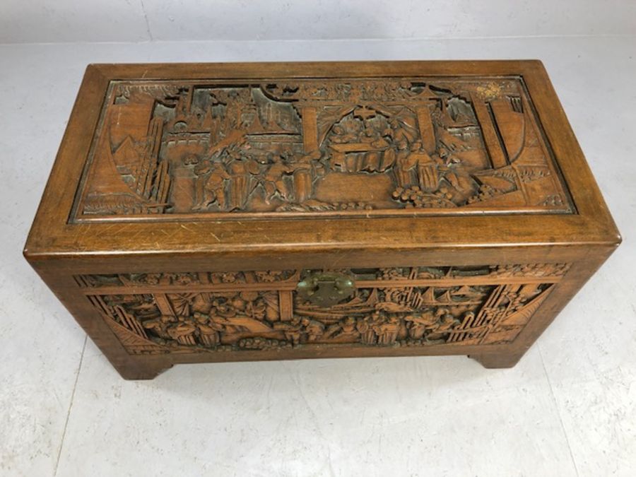 Heavily carved Chinese camphor wood chest with two internal trays, approx 103cm x 52cm x 60cm - Image 2 of 8