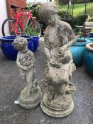 Two garden statues, a lady pouring water and a child, the largest approx 63cm in height