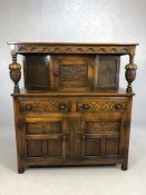 Carved oak buffet with baluster columns, carved detailing, cupboards and drawers, approx 122cm x