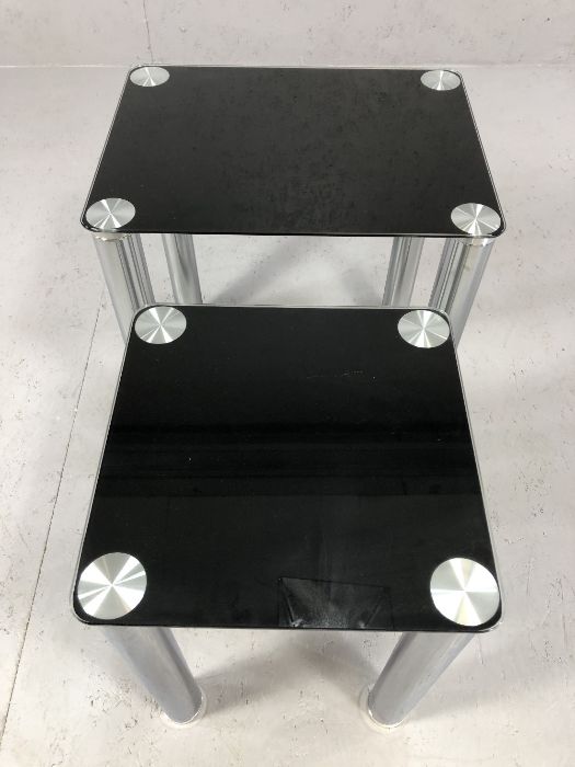 Modern black glass and chrome nest of two tables, largest approx 45cm x 35cm x 50cm tall