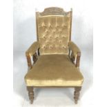 Antique upholstered armchair on castors