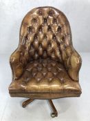 Brights of Nettlebed brown leather swivel desk chair / armchair on castors with button back and stud