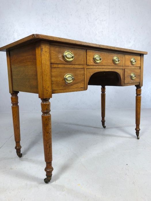 Antique kneehole writing desk on turned legs with original castors, five drawers and brass - Image 6 of 6