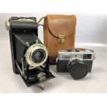 Vintage cameras: an Olympus 35RC and a Kodak SIX-20 folding Brownie with leather case