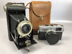 Vintage cameras: an Olympus 35RC and a Kodak SIX-20 folding Brownie with leather case