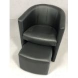 Single modern black tub chair with pull-out foot stool