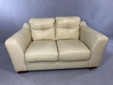 Contemporary cream leather two-seater sofa, approx 150cm in length (A/F)