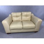 Contemporary cream leather two-seater sofa, approx 150cm in length (A/F)
