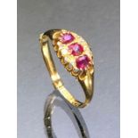 18ct Gold ring set with three Rubies and flanked by rows of Diamonds, fully hallmarked size 'P' (