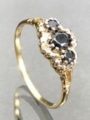 9ct Gold ring set with three faceted Sapphires and surrounded by diamonds size 'U' and 2.2g